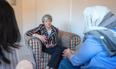 Theresa May (centre) talks with a case worker (left) and domestic violence survivor at Advance Charity offices in West London when she was prime minister in May 2019. 