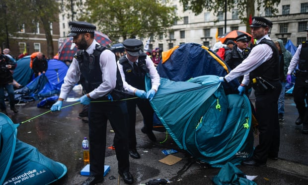 Police officers remove tents belonging to Extinction Rebellion activists in Westminster.