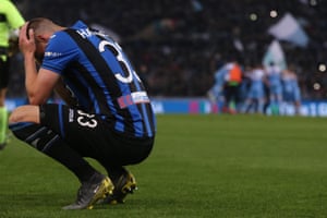 Atalanta’s Hans Hateboer shows his dejection as Lazio celebrate.