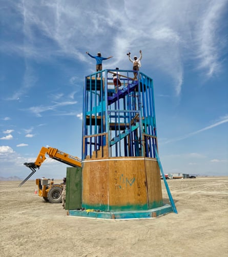 People stand atop a building in the middle of being constructed