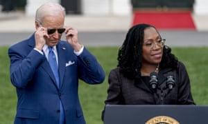 Joe Biden puts on his sunglasses as Judge Ketanji Brown Jackson speaks during an event on the South Lawn of the White House in Washington, Friday, April 8, 2022, celebrating the confirmation of Jackson as the first Black woman to reach the Supreme Court.