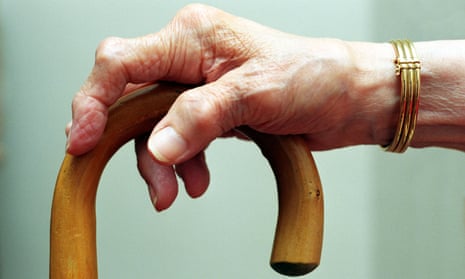 Arthritic woman's hand on her walking stick