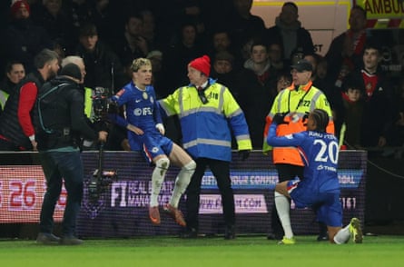 Alejandro Garnacho perches on the advertising hoardings after putting Chelsea ahead for the first time