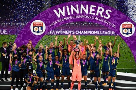 Lyon players celebrate with the trophy after winning the Women’s Champions League final in 2020.