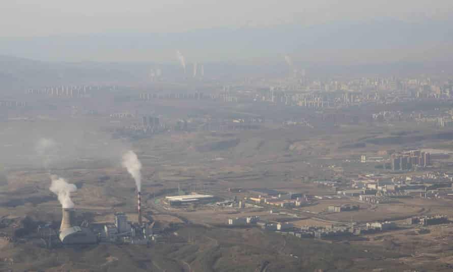 Smoke and steam rise from towers at the coal-fired Urumqi power plant in Xinjiang, western China.