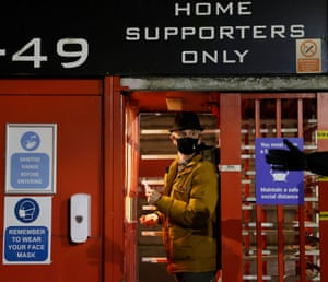 A Charlton supporter scans his ticket on the first day of fans being allowed back into stadiums before the game against MK Dons in League One at the Valley on 2 December.