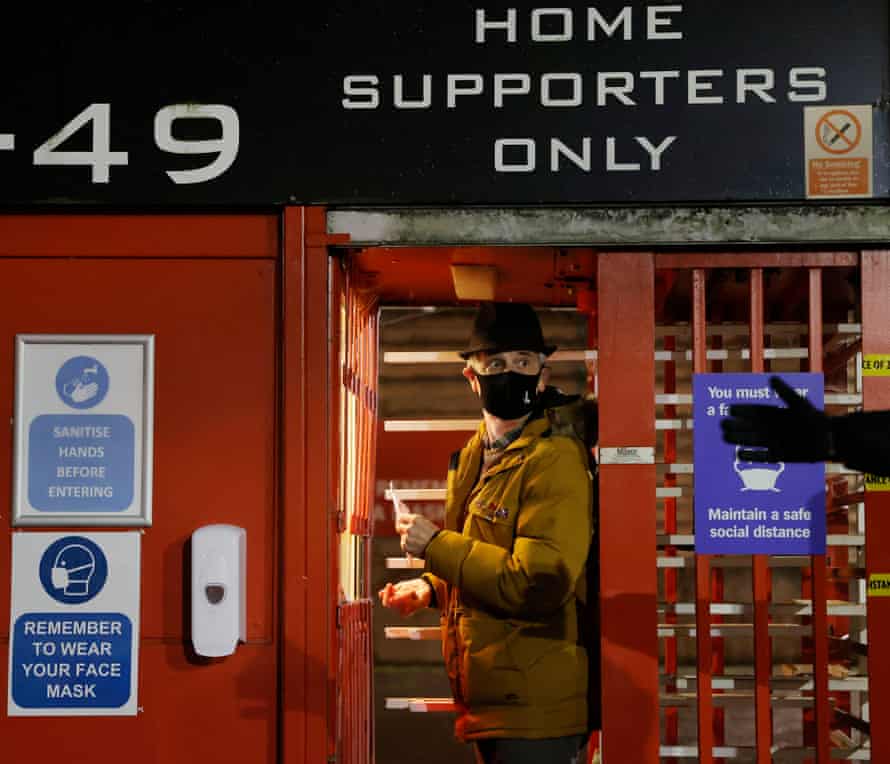 A Charlton supporter scans his ticket on the first day of fans being allowed back into stadiums before the game against MK Dons in League One at the Valley on 2 December.