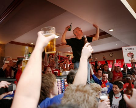Pete Boyle leads the prematch singing at the Bishop Blaze pub near Old Trafford.