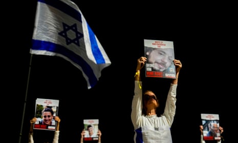 Families and supporters of Israeli hostages held by Hamas in Gaza hold their photos during a rally calling for their release, in Tel Aviv, Israel.