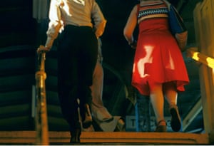 a Willy Spiller photo titled 'Catching the Light, 1984': two figures seen from behind ascend some New York subway steps with shafts of sunlight hitting them