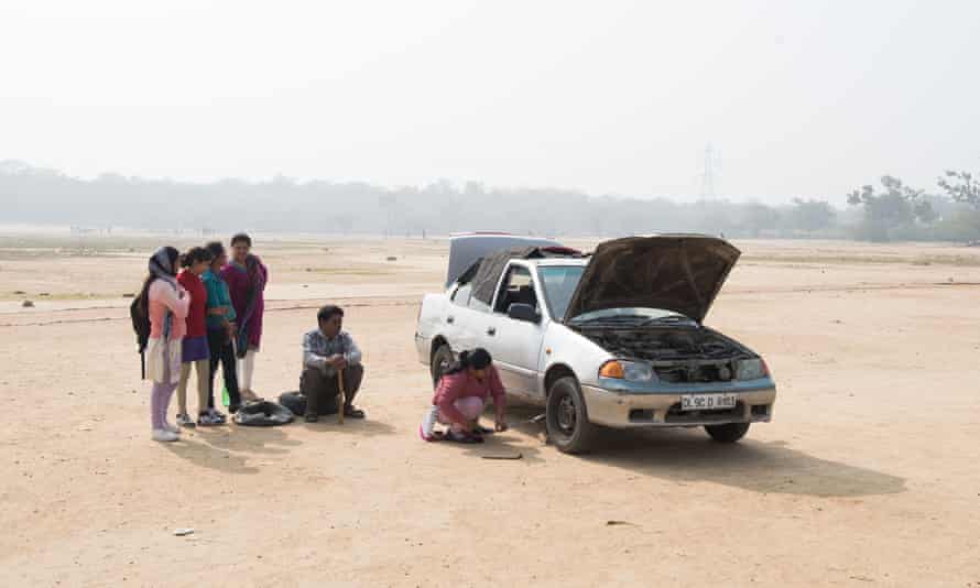 Pushpa changes a flat tyre as part of a driving workshop outside New Delhi.