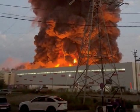 Smoke rises from a Wildberries warehouse on fire after an attack in Nevinnomyssk, Russia.