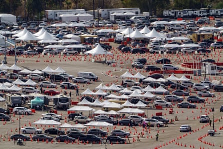 Drivers wait in line at the mass Covid-19 vaccination site in the parking lot of Dodger Stadium.