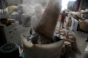 A worker puts styrofoam in a shredder at a recycling plant in Valenzuela City, north of Manila.