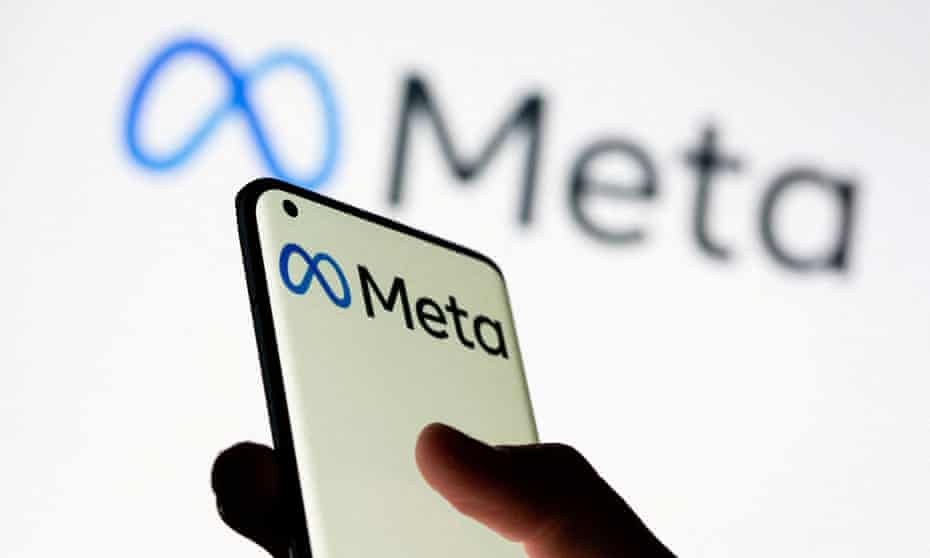 Woman holds smartphone with Meta logo