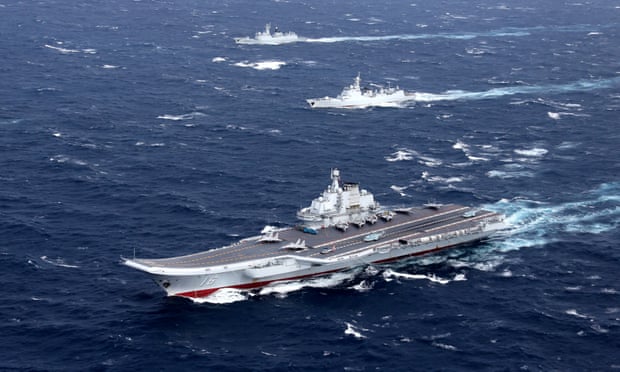China’s Liaoning aircraft carrier conducts a drill in the South China Sea. State media has warned of conflict if the US attempts to block access to islands there.