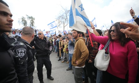 Israeli police officers and protesters in Tel Aviv on Monday.
