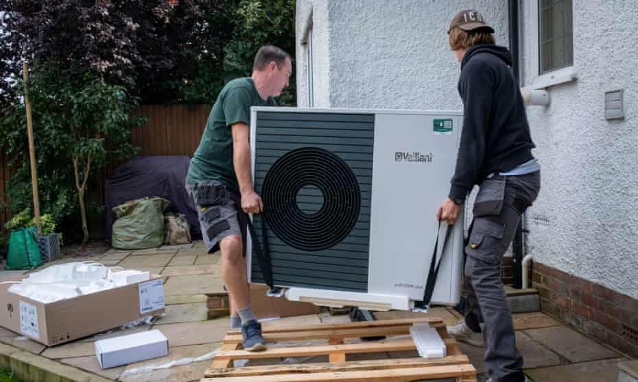 'Although GBP450m sounds like a big number, it will only enable 30,000 installations a year.' Heat pump installers installing a new unit.