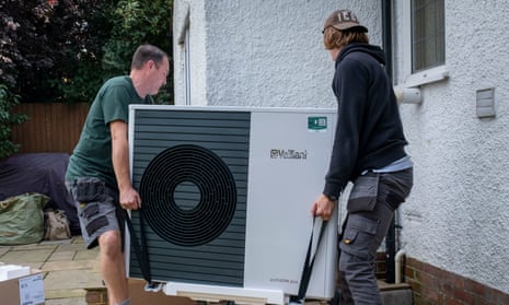 Workmen installing a heat pump in Folkestone