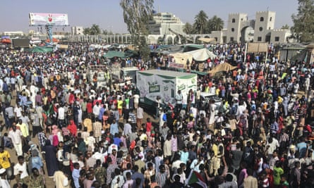 Sudanese protesters march with national flags