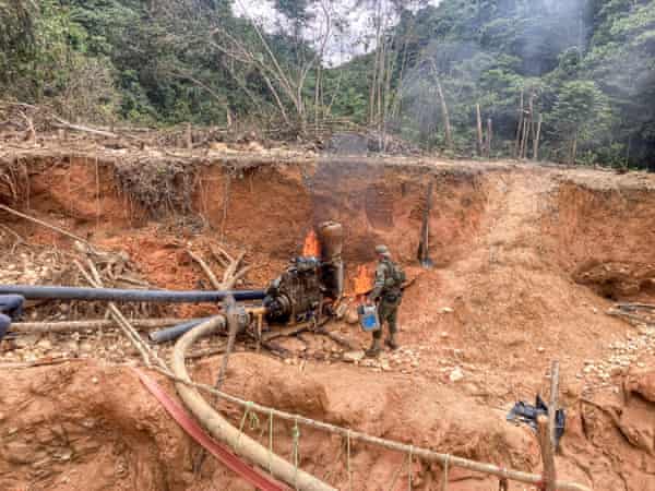 Felipe Finger torches a motor used by illegal gold miners