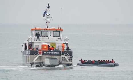 A group of people in a dinghy are rescued by a Border Force boat near Folkestone in Kent on Saturday