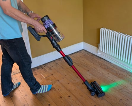 Man using a Hepa vacuum cleaner for hay fever prevention