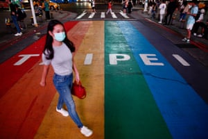 A pedestrian wears a mask in Taipei.