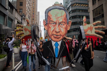 A pro-Palestinian protest in New York City, September 2024. Protesters carry a large cardboard cutout of Israeli prime minister Benjamin Netanyahu with blood on his hands.