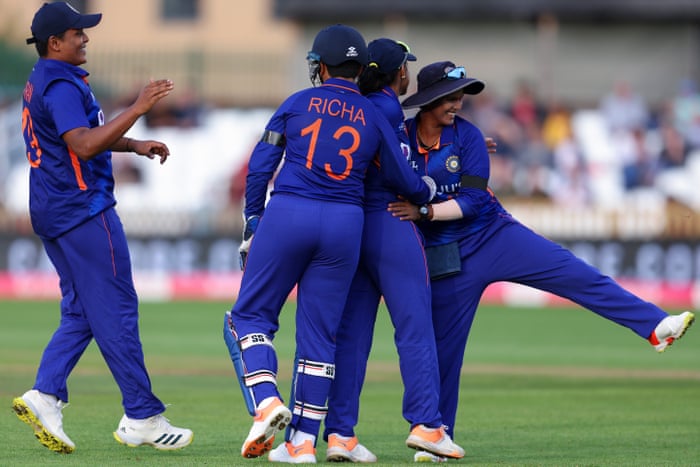 Sneh Rana of India celebrates with teammates after catching out Danni Wyatt of England.