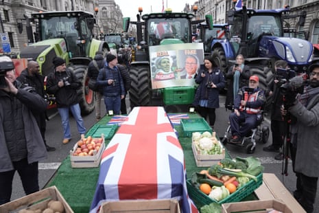 A coffin draped in the Union flag symbolising the death of British farming during a protest by farmers in Westminster.