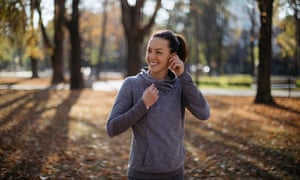 Girl listening the music in the city park before training