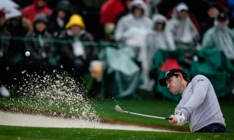 Patrick Cantlay hits from the bunker on the 18th hole during the weather delayed second round of the 2023 Masters golf tournament.