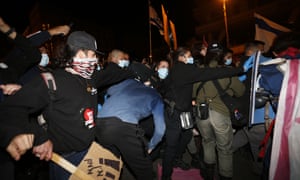 Coronavirus live news: Australian state of Victoria goes 30 days without new cases; UK records 479 more deaths | World news 2 Israeli police officers detain a protester during a demonstration against Israel’s Prime Minister Benjamin Netanyahu, in Jerusalem.