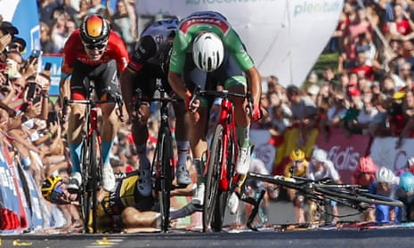 Primoz Roglic falls after a collision with Fred Wright (left, in red) close to the end of stage 16.