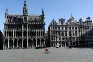 A lone cyclist crosses a square in Brussels