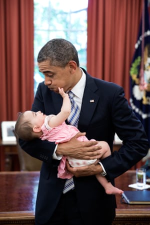 The president holds six-month-old Talia Neufeld