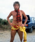 Rod Stewart in nothing but very brief briefs, a tartan scarf and football banner around his hips