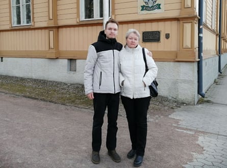 Nikita and Olga Belov stood on the street wearing winter coats