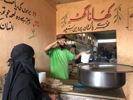 A woman in a black niqab and abaya
