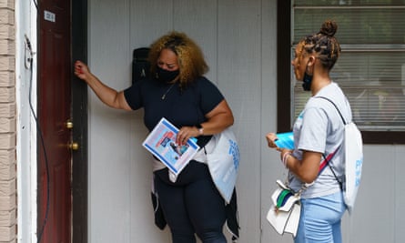 Volunteers and staffers knock on a door during a vaccine outreach effort in Birmingham, Alabama.