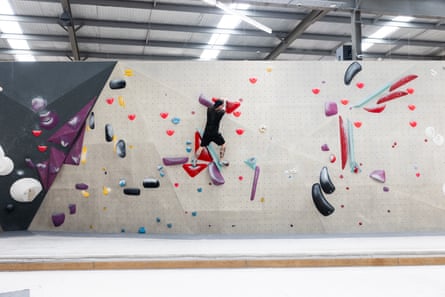 A man climbing a bouldering wall