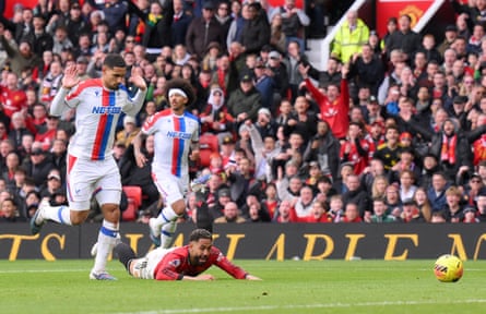 Maxence Lacroix holds up his hands to plead innocence after bringing down the prone Matheus Cunha