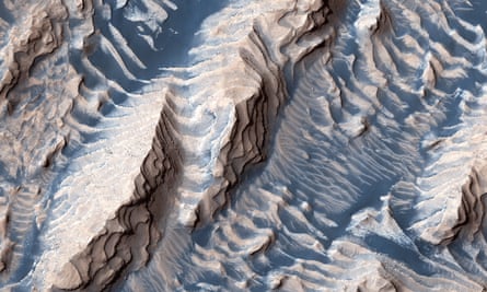 Many craters on Mars appear to have been filled with sediment at one time. Long dry, the sediments are being eroded by windblown sand. Some layers are more resistant to erosion than others, producing the stair-stepped ridges and valleys seen within Danielson crater.