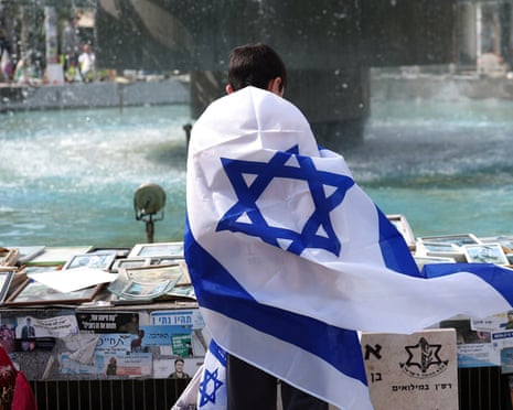 A boy wrapped in an Israel flag