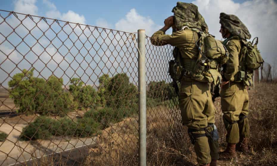 Israeli soldiers patrol the Israeli-Gaza border in 2014.