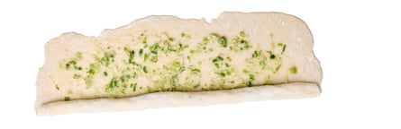 Felicity Cloake’s Taiwanese scallion or spring onion pancake 5. Divide the dough into four equal parts. Put three of the pieces of dough back under cover. On a lightly floured surface, roll out the fourth piece of dough into as thin a rectangle as possible, towards the end stretching it with your fingers. Brush about a quarter of the spring onion paste all over the top, leaving a small border around the edge.