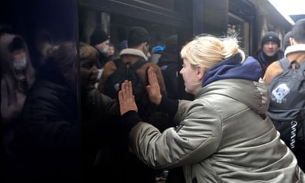 A woman says goodbye as a train with evacuees is about to leave Kyiv’s railway station on Wednesday.
