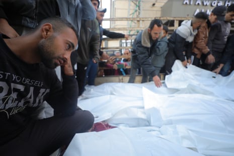Relatives of the Palestinians killed in Israeli attack on Nuseirat refugee camp, mourn at Al-Awda hospital, 11 December.