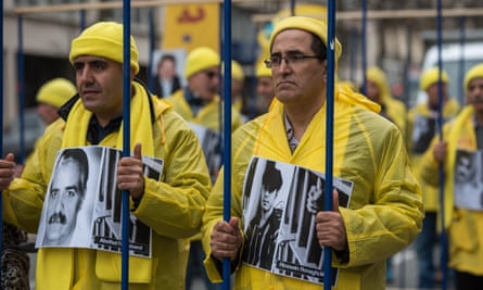 Protesters carry bars and images of Iranian political prisoners in Paris